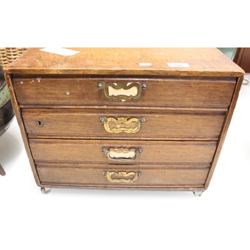 756 - Oak four drawer cabinet on castors, 42cm wide x 35cm tall.