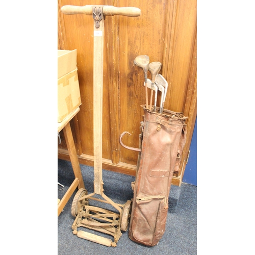 771 - Vintage lawnmower and a collection of golf clubs in vintage leather case.