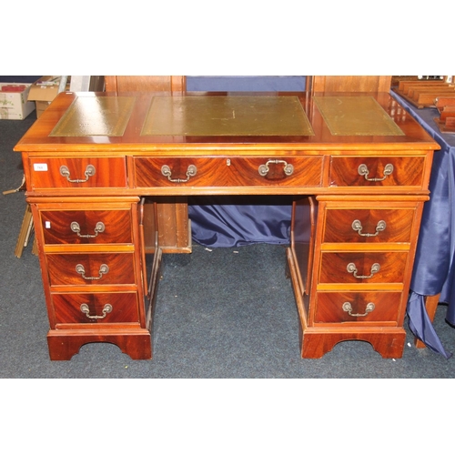 768 - Mahogany twin pedestal nine drawer desk with green leather skiver.