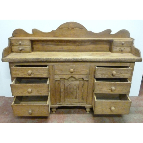 529 - Victorian scumbled pine dresser, the shaped gallery with short drawers above further short drawers a... 