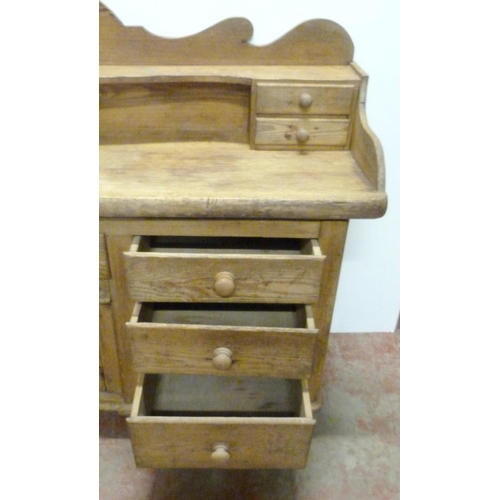 529 - Victorian scumbled pine dresser, the shaped gallery with short drawers above further short drawers a... 