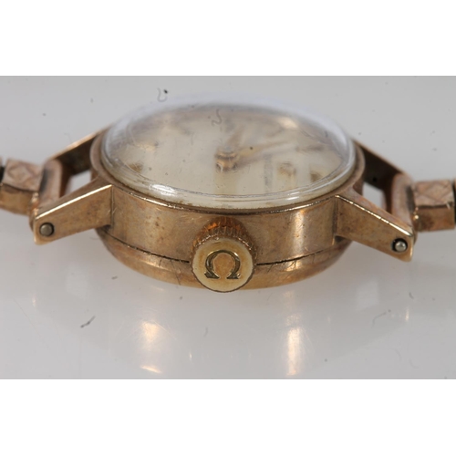 206 - 9ct gold ladies Omega wristwatch, the champagne dial with baton markers, on 9ct gold strap, with spa... 