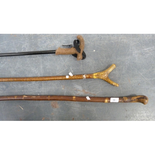 59 - Five assorted walking sticks to include a crook and a gnarled stick.  (5)