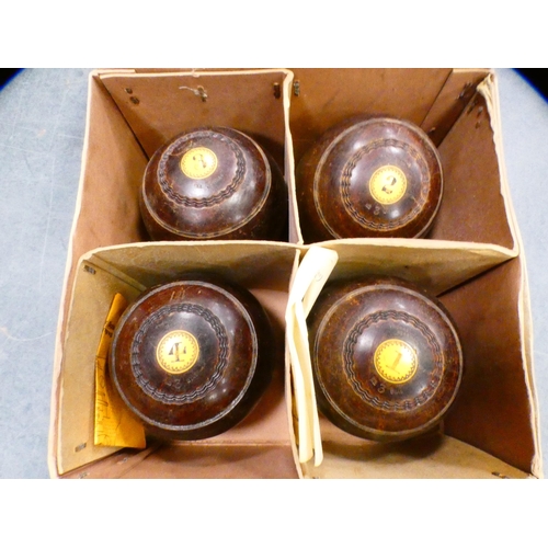 81 - Set of four lawn bowling bowls, monogrammed to the mounts, in a Thomas Taylor of Glasgow box.