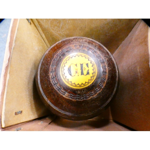 81 - Set of four lawn bowling bowls, monogrammed to the mounts, in a Thomas Taylor of Glasgow box.