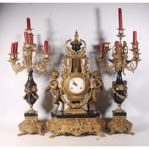 64 - Mid-20th century Italian black and gilt metal clock garniture set.