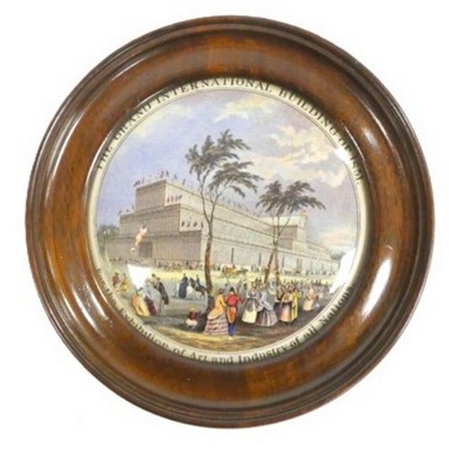 Victorian framed pot lid, 'The Grand International Building of 1851 For the Exhibition of Art and Industry of all Nations', showing views of the Crystal Palace and pedestrians. 18cm diameter.