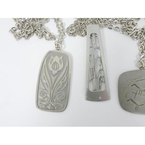 55 - Four Jorgen Jensen pewter plaque pendants.