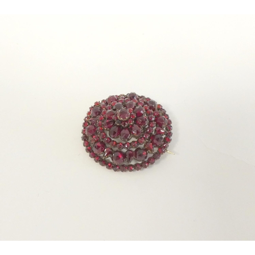 62 - 19th century pyrope garnet circular tiered brooch, also 'garnet' gold, 7.3g gross.