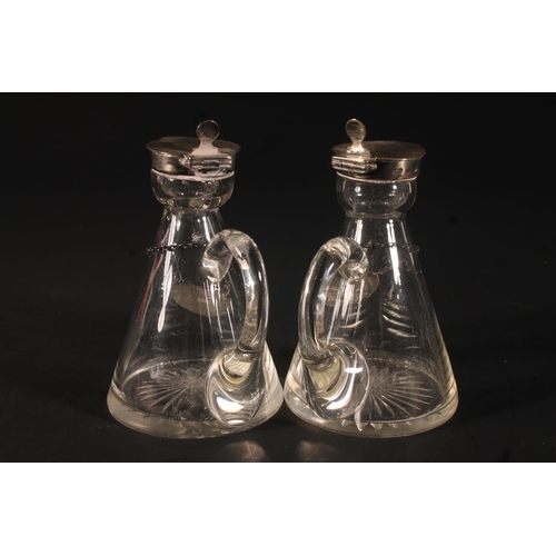 32 - Pair of Edwardian whisky noggins, the hinged silver covers over a conical glass bottle with star cut... 