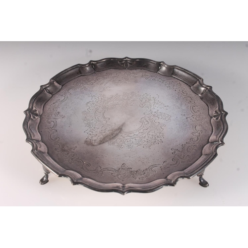 35 - Edwardian silver salver, engraved with foliate scrolls within a cast piecrust rim, on four pad feet,... 