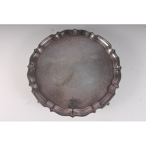 35 - Edwardian silver salver, engraved with foliate scrolls within a cast piecrust rim, on four pad feet,... 