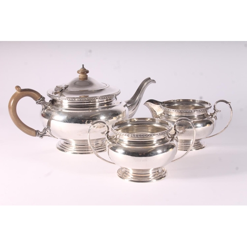 37 - Geo. V three piece silver tea service, the teapot with bakelite finial and loop handle, Blackmore an... 