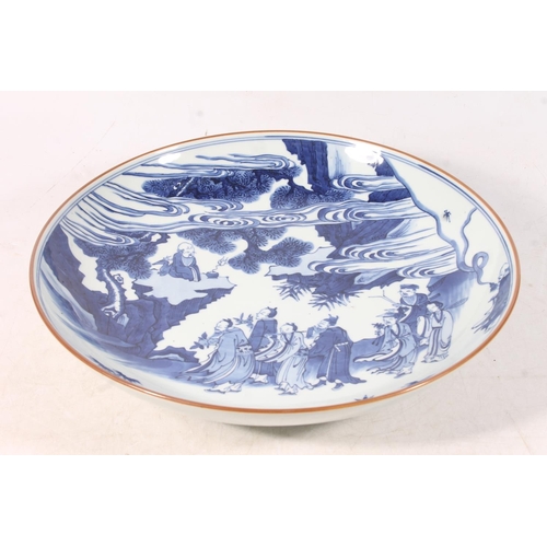 437 - Chinese Kangxi style blue and white charger, Painted with a scene of figures looking up at an immort... 