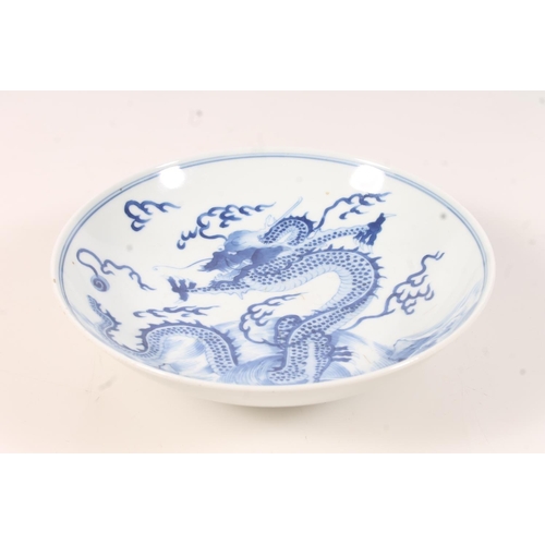 439 - Chinese blue and white dragon dish, Decorated with the four claw dragon chasing the flaming pearl, w... 