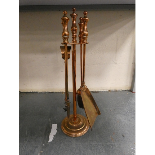 88 - Copper coal depot with Delft-style handle, and a copper companion stand with fire irons.