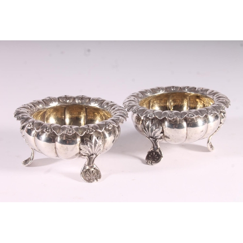 91 - Pair of Geo. IV silver table salts, of cauldron form with cast foliate borders, shaped squat bodies ... 