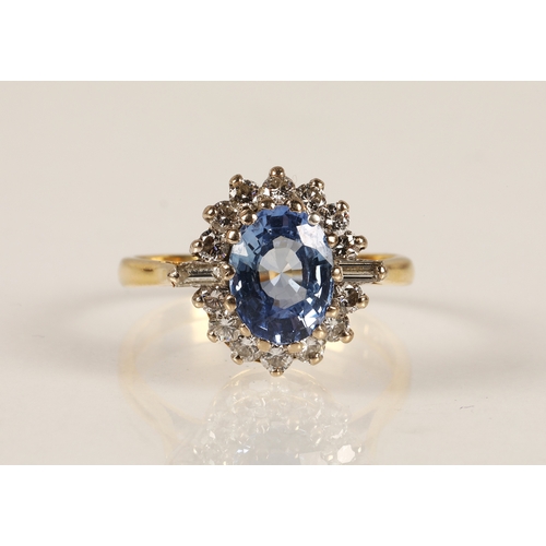 233 - 18ct gold ring set with a central pale blue gemstone possibly sapphire, surrounded by a halo of roun... 