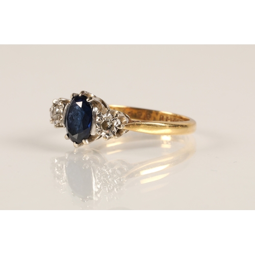 217 - 18ct gold ring set with a central blue gemstone flanked by two diamonds in illusion settings, ring s... 