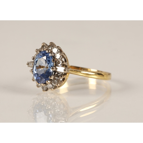 233 - 18ct gold ring set with a central pale blue gemstone possibly sapphire, surrounded by a halo of roun... 