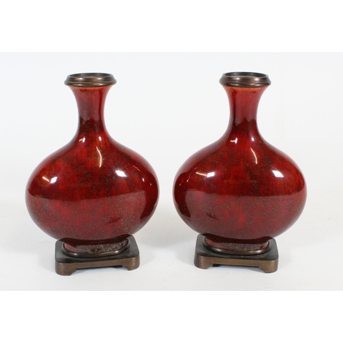 468 - Pair of Chinese sang-de-boeuf porcelain bottle vases, the flask shape bodies with bronze rims and on... 