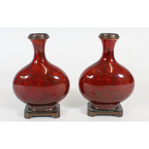 468 - Pair of Chinese sang-de-boeuf porcelain bottle vases, the flask shape bodies with bronze rims and on... 