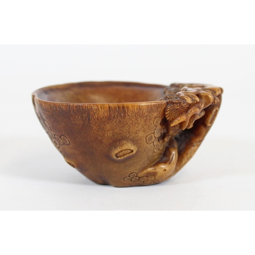 469 - Chinese Rhinoceros Horn libation cup, mid to late Qing period, the handle formed as a trunk extendin... 