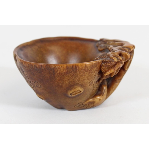 469 - Chinese Rhinoceros Horn libation cup, mid to late Qing period, the handle formed as a trunk extendin... 