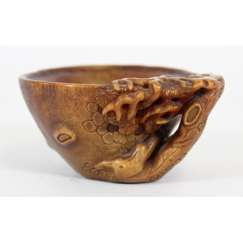 469 - Chinese Rhinoceros Horn libation cup, mid to late Qing period, the handle formed as a trunk extendin... 