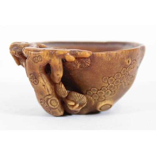 469 - Chinese Rhinoceros Horn libation cup, mid to late Qing period, the handle formed as a trunk extendin... 