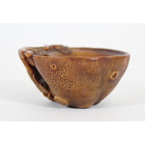 469 - Chinese Rhinoceros Horn libation cup, mid to late Qing period, the handle formed as a trunk extendin... 