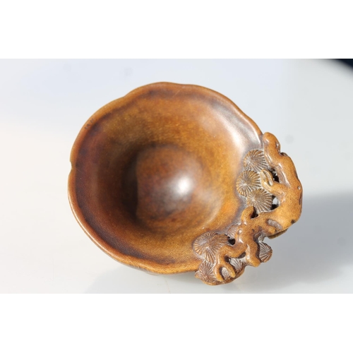 469 - Chinese Rhinoceros Horn libation cup, mid to late Qing period, the handle formed as a trunk extendin... 