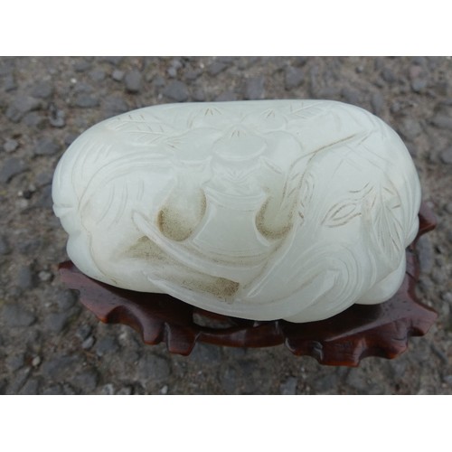 315 - Chinese celadon jade carving of a recumbent kylin, Qing Dynasty, on a padouk stand, 9cm, and another... 