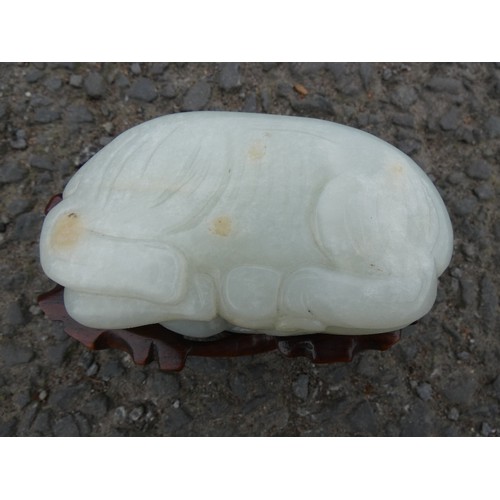 315 - Chinese celadon jade carving of a recumbent kylin, Qing Dynasty, on a padouk stand, 9cm, and another... 