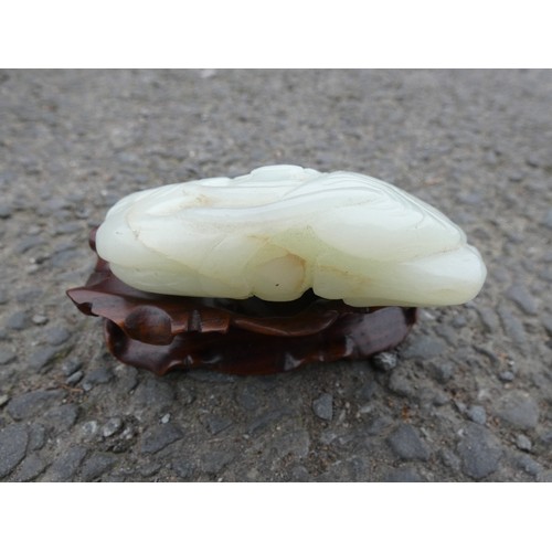 315 - Chinese celadon jade carving of a recumbent kylin, Qing Dynasty, on a padouk stand, 9cm, and another... 