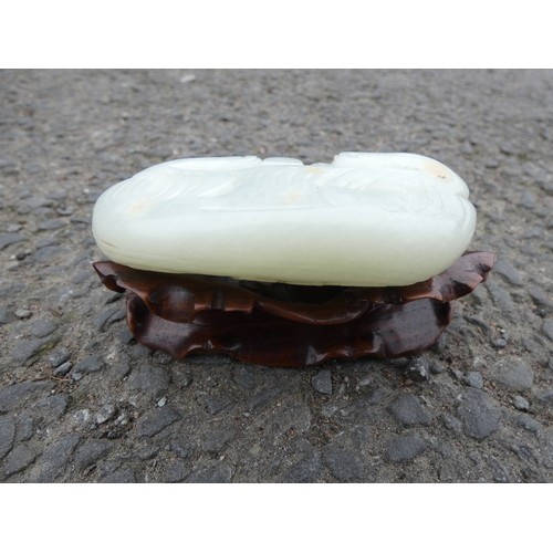 315 - Chinese celadon jade carving of a recumbent kylin, Qing Dynasty, on a padouk stand, 9cm, and another... 