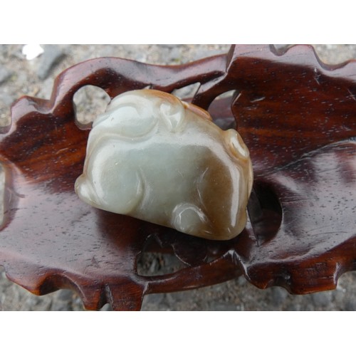 315 - Chinese celadon jade carving of a recumbent kylin, Qing Dynasty, on a padouk stand, 9cm, and another... 