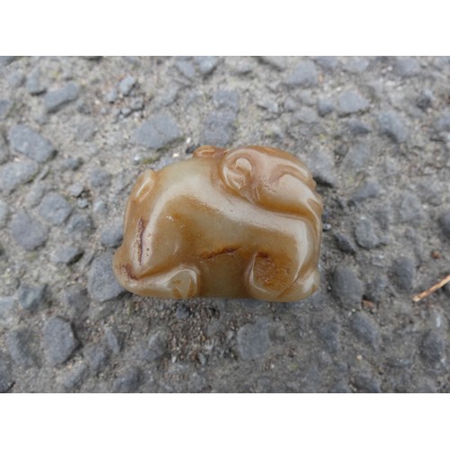 315 - Chinese celadon jade carving of a recumbent kylin, Qing Dynasty, on a padouk stand, 9cm, and another... 