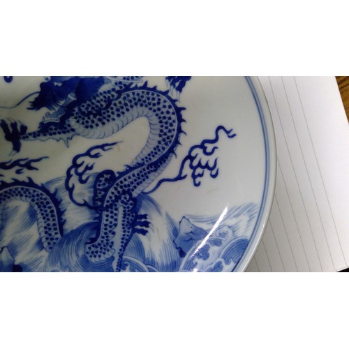 439 - Chinese blue and white dragon dish, Decorated with the four claw dragon chasing the flaming pearl, w... 