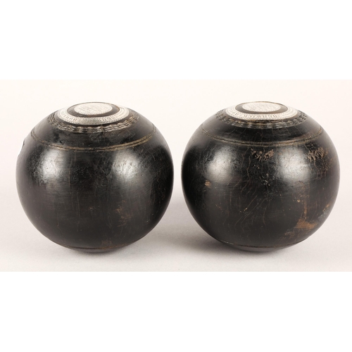43 - Pair of lawn bowls inset with white metal, inscribed Berwick Bowling Club Handicap Prize 1893