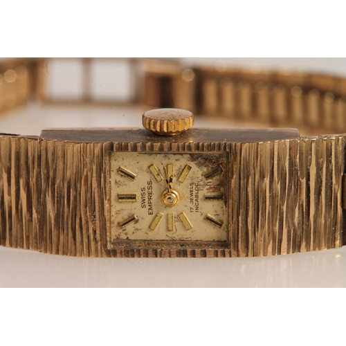 189 - 9ct yellow gold Smiths Empress ladies wristwatch on textured 9ct gold strap, the face with baton mar... 