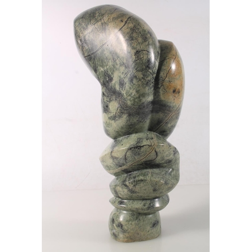 22 - Zimbabwean carved serpentine abstract figure signed to base Moses Masya, 35cm high.