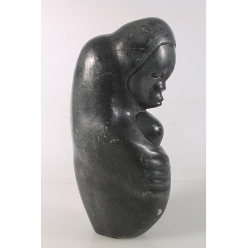 23 - Zimbabwean carved serpentine figure of a mother and child, signed to base Amonmwa, 31cm high.
