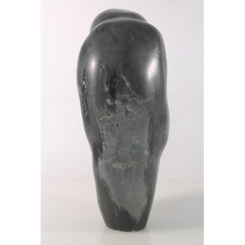 23 - Zimbabwean carved serpentine figure of a mother and child, signed to base Amonmwa, 31cm high.