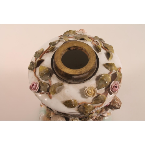 42 - Antique Meissen style lamp base with four cherub supports and relief floral decoration, blue crossed... 