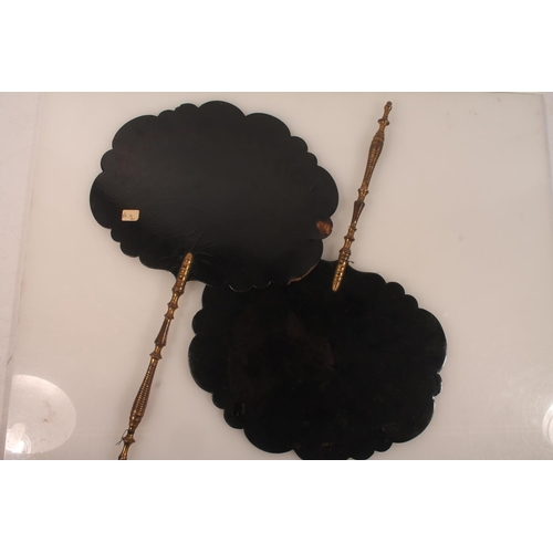 48 - Pair of lacquered hand screens with painted floral vignettes, 42cm long.