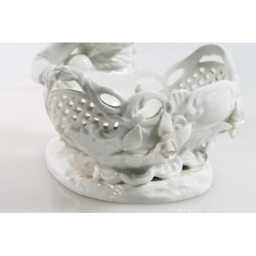 56 - Antique porcelain basket modelled with figure clutching flower support, Meissen style blue crossed s... 