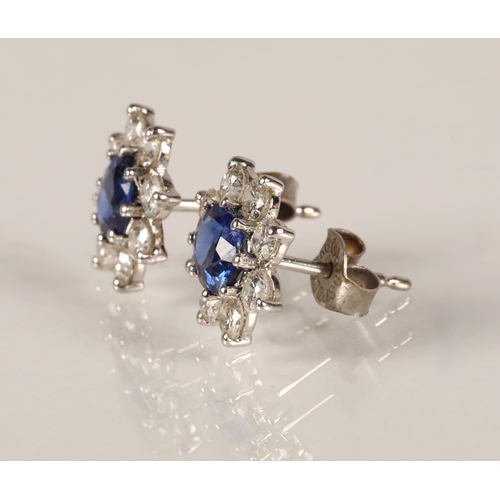 64 - Pair of ladies 18ct white gold sapphire and diamond earrings, central sapphire surrounded by eight s... 