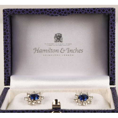 64 - Pair of ladies 18ct white gold sapphire and diamond earrings, central sapphire surrounded by eight s... 