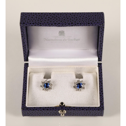 64 - Pair of ladies 18ct white gold sapphire and diamond earrings, central sapphire surrounded by eight s... 